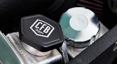 Close-up of CFB Series reservoir cap on a coolant or fluid container under Classic Ford Bronco hood.