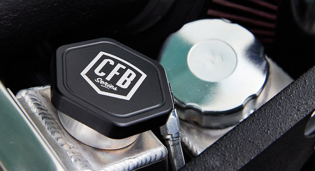 Close-up of CFB Series reservoir cap on a coolant or fluid container under Classic Ford Bronco hood.