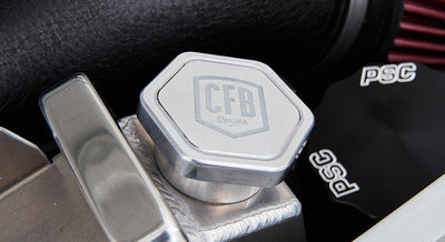 Metal cap labeled CFB Series on polished aluminum component inside engine bay of a Classic Ford Bronco