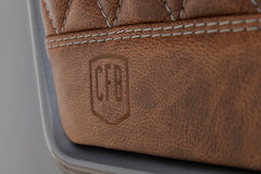 Brown leather with embossed CFB logo and detailed stitching on Classic Ford Bronco seat