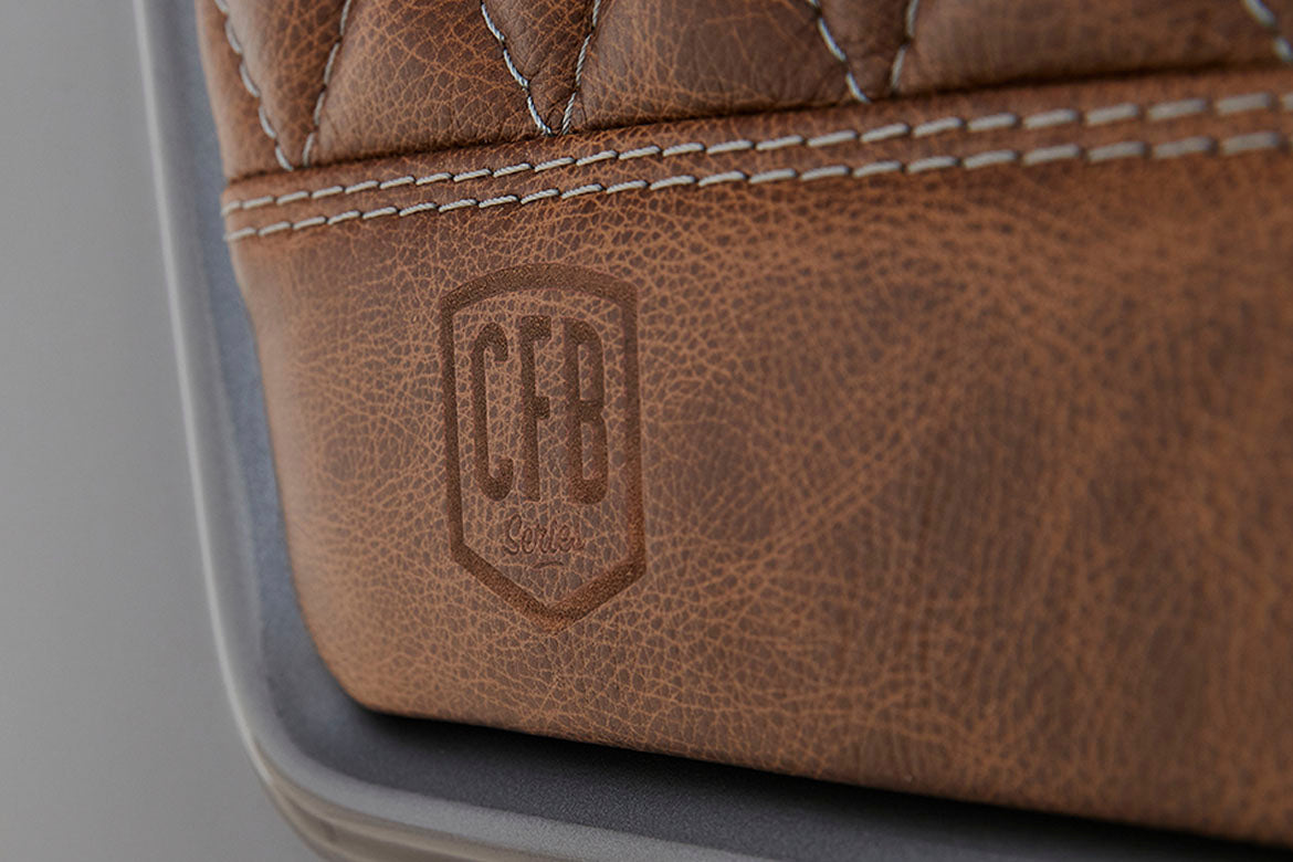Brown leather with embossed CFB logo and detailed stitching on Classic Ford Bronco seat