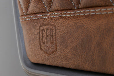 Brown leather with embossed CFB logo and detailed stitching on Classic Ford Bronco seat