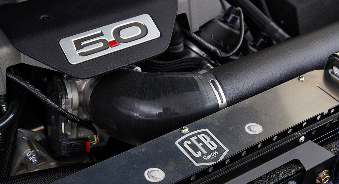 Engine bay showing 5.0 liter engine cover, black tubing, and CFB Series logo on radiator support