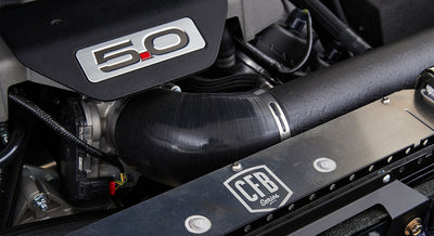 Engine bay showing 5.0 liter engine cover, black tubing, and CFB Series logo on radiator support