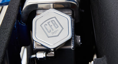 Silver hexagonal cap engraved with 'CFB Series' on a blue painted surface