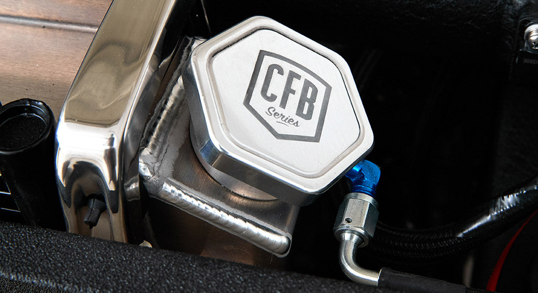 Metallic cap with CFB Series logo attached to engine component
