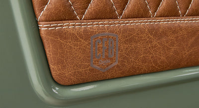 Close-up of brown leather seat with 'CFB Series' logo embossed