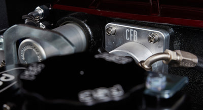 Close-up of black engine parts with CFB logo and hardware in Classic Ford Bronco