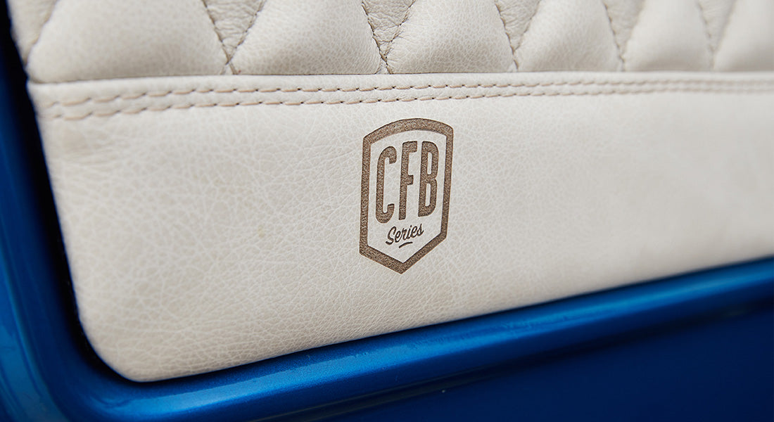 Close-up of beige leather upholstery with CFB Series logo in a Classic Ford Bronco
