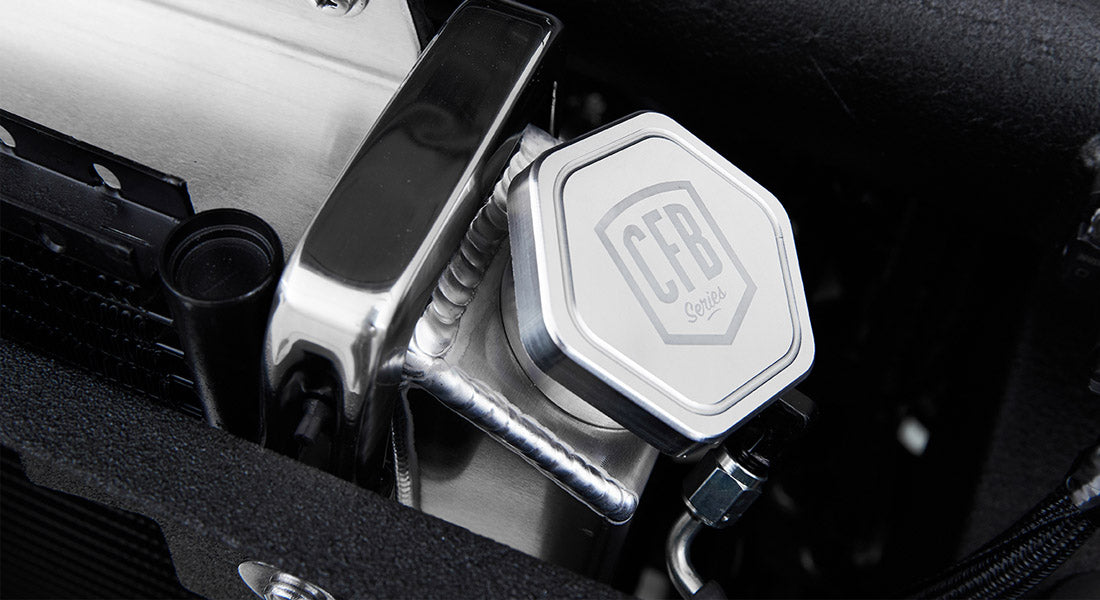Close-up of metal component engraved with CFB Series logo in Classic Ford Bronco engine bay