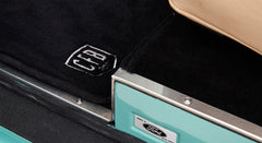 Interior door sill area of Classic Ford Bronco featuring black carpet with CFB logo and Ford Motor Company plaque