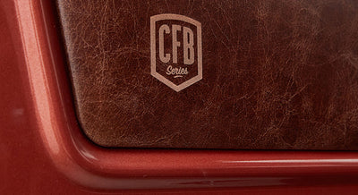 Brown leather panel with CFB Series logo embossed, framed by red metallic surface