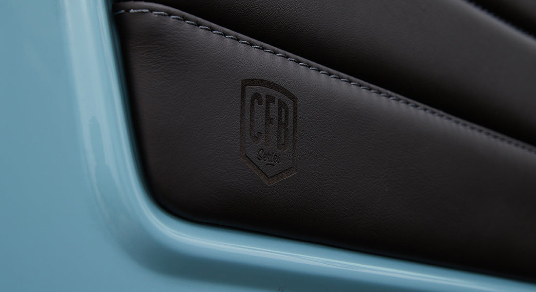 Leather panel branding embossed with CFB logo on light blue door frame of Classic Ford Bronco.