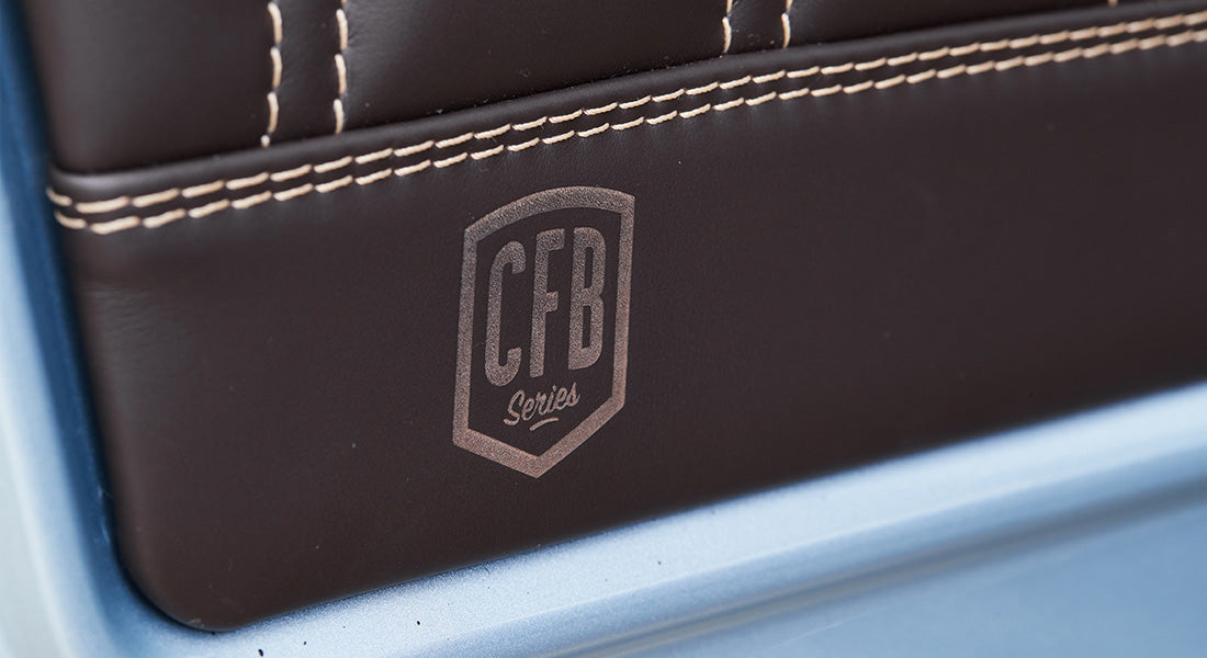Detail of white contrast stitching and CFB Series logo on brown leather in Classic Ford Bronco