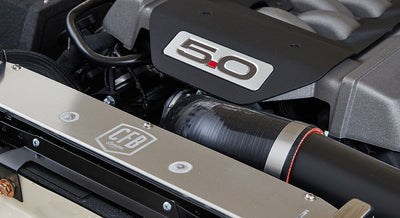Engine bay featuring 5.0-liter engine and CFB logo on metal component in Classic Ford Bronco