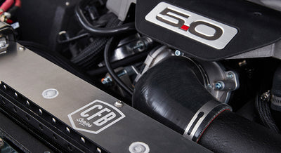 5.0 emblem on engine cover with surrounding hoses and engine components in Classic Ford Bronco