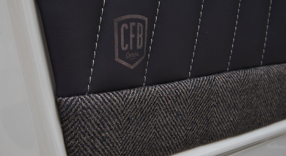 Close-up of leather and herringbone fabric with 'CFB Series' embroidery inside Classic Ford Bronco