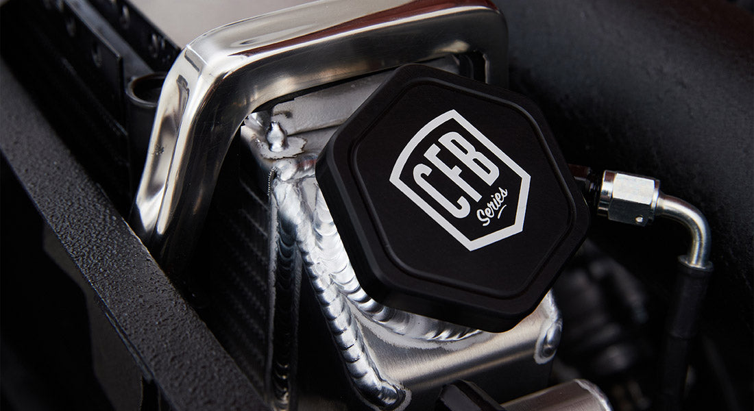 Aluminum classic Bronco radiator neck with black CFB Series cap and polished metal brace