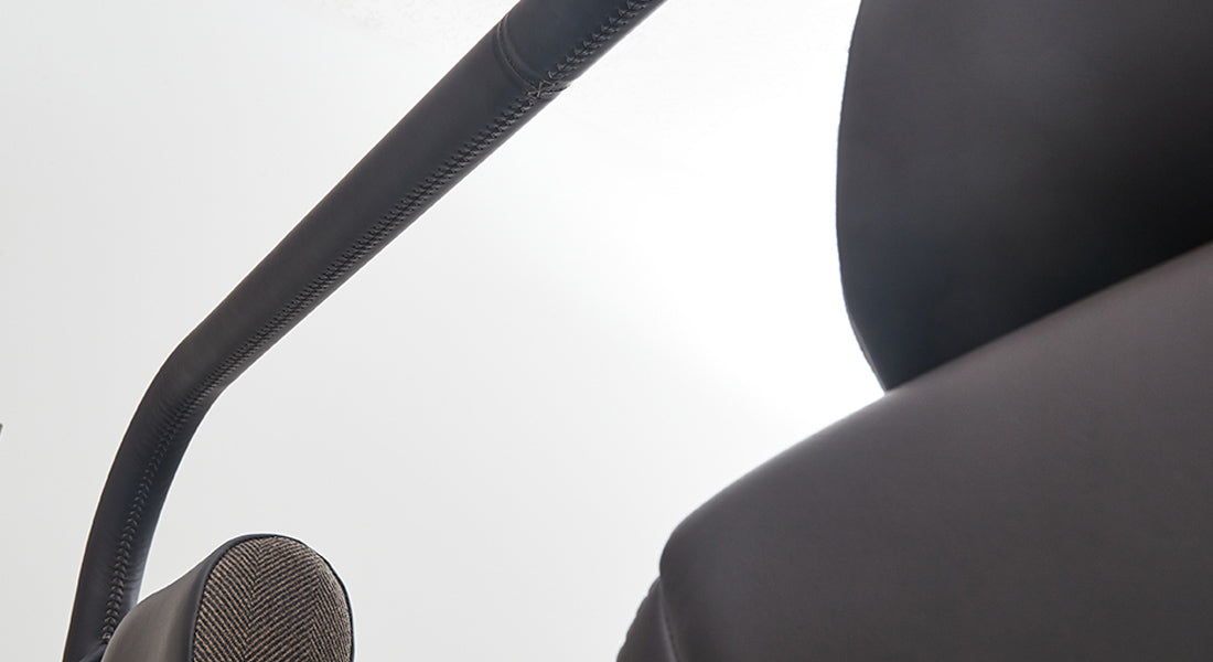Side view of black padded roll cage and seat back inside Classic Ford Bronco