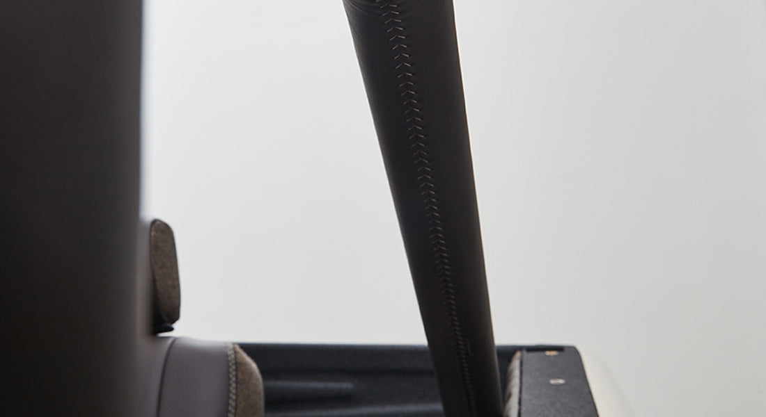 Close-up of black padded roll cage frame and seat back inside Classic Ford Bronco