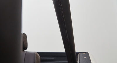 Close-up of black padded roll cage frame and seat back inside Classic Ford Bronco