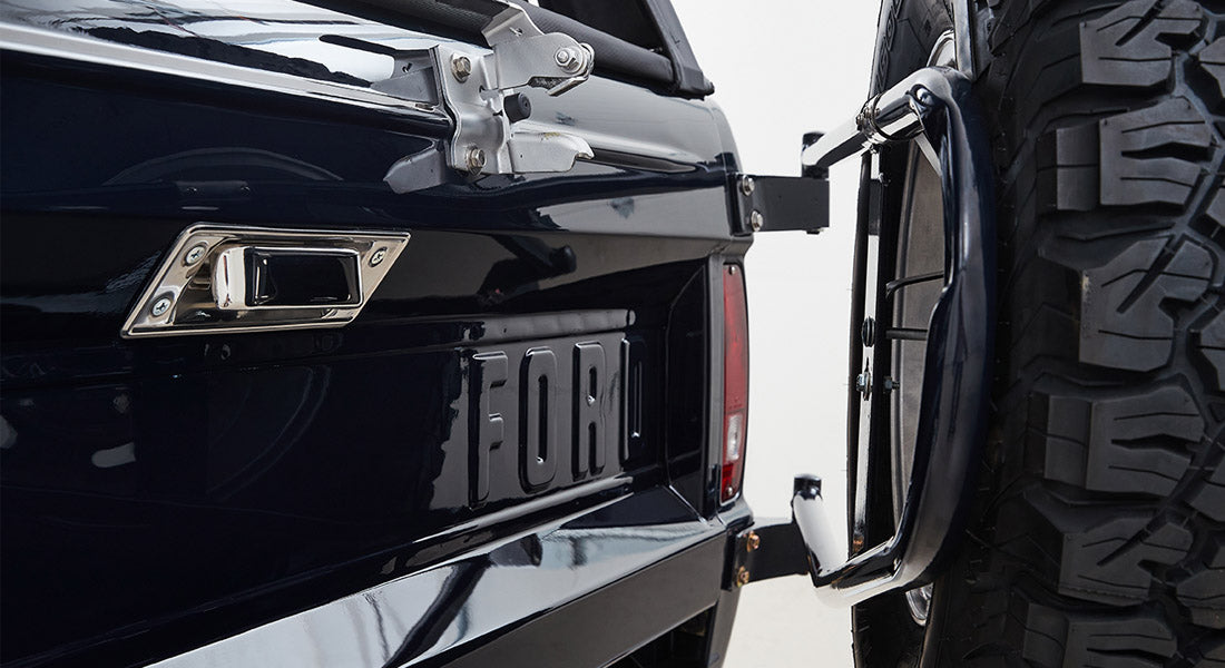 Rear view of Classic Ford Bronco showing tailgate with FORD lettering and full-size spare tire
