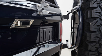 Rear view of Classic Ford Bronco showing tailgate with FORD lettering and full-size spare tire