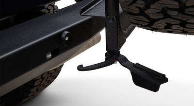 Black metal carrier latch mechanism and treaded tire visible under Classic Ford Bronco rear