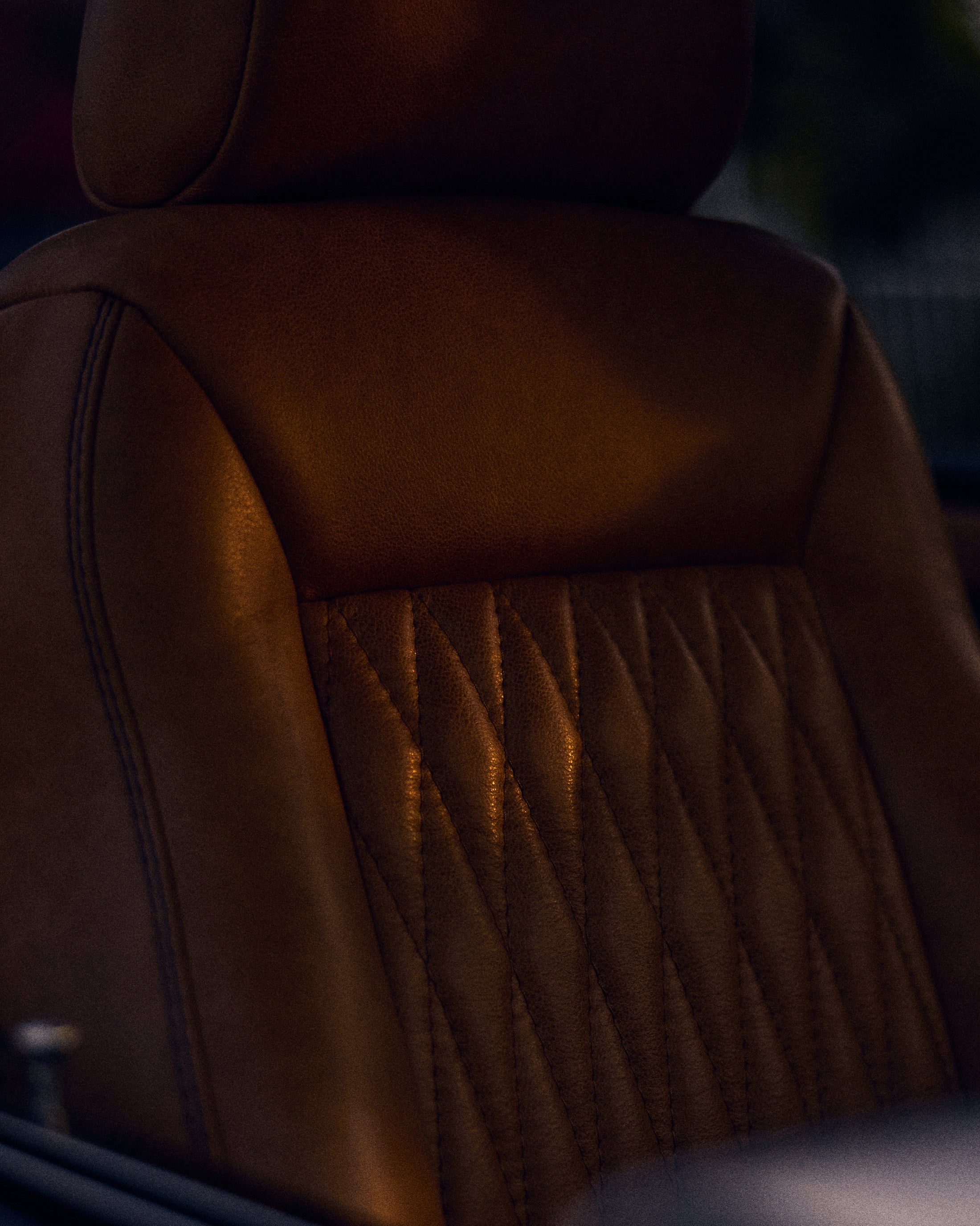 Detailed view of brown leather seat with vertical stitching pattern in Classic Ford Bronco