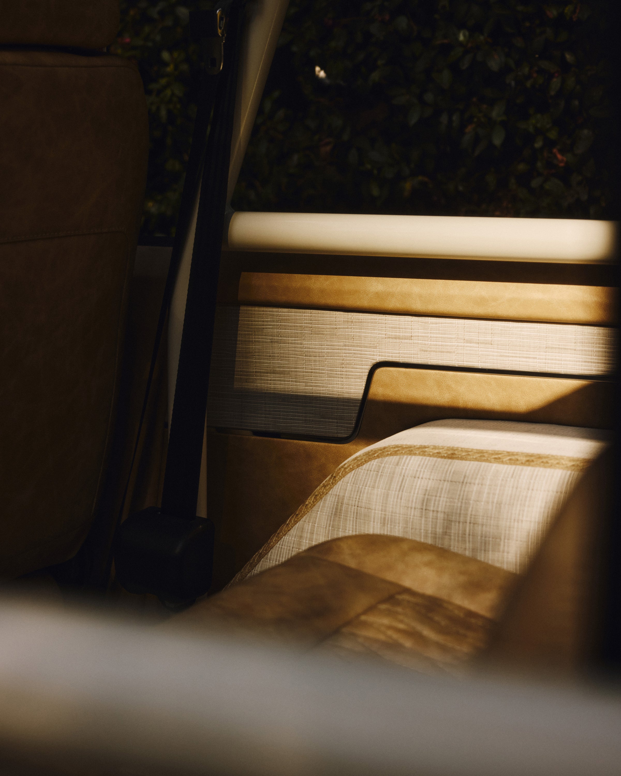 Close-up of tan seat upholstery with seatbelt inside a vehicle