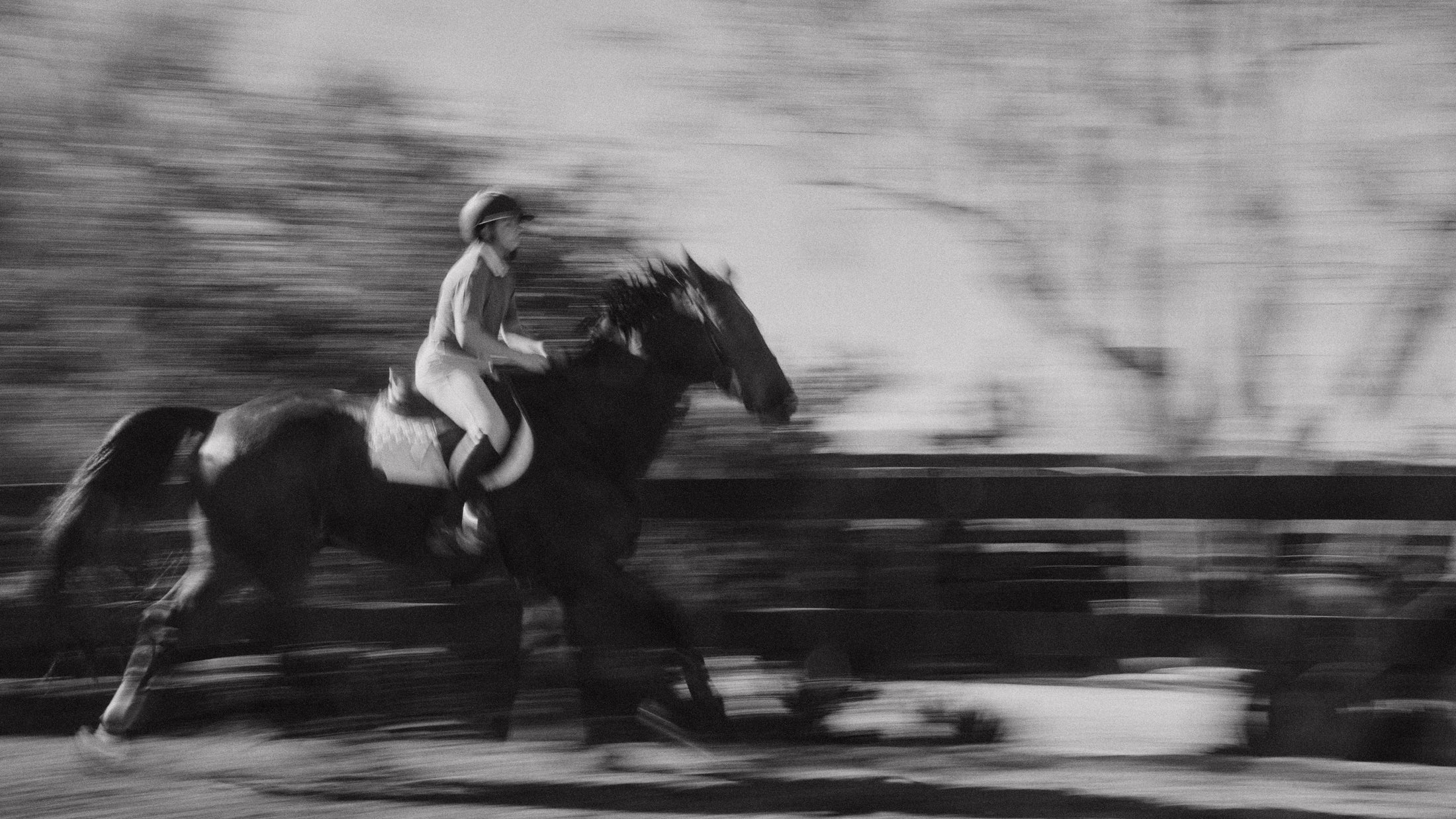 Blurred motion image of a rider on a galloping horse