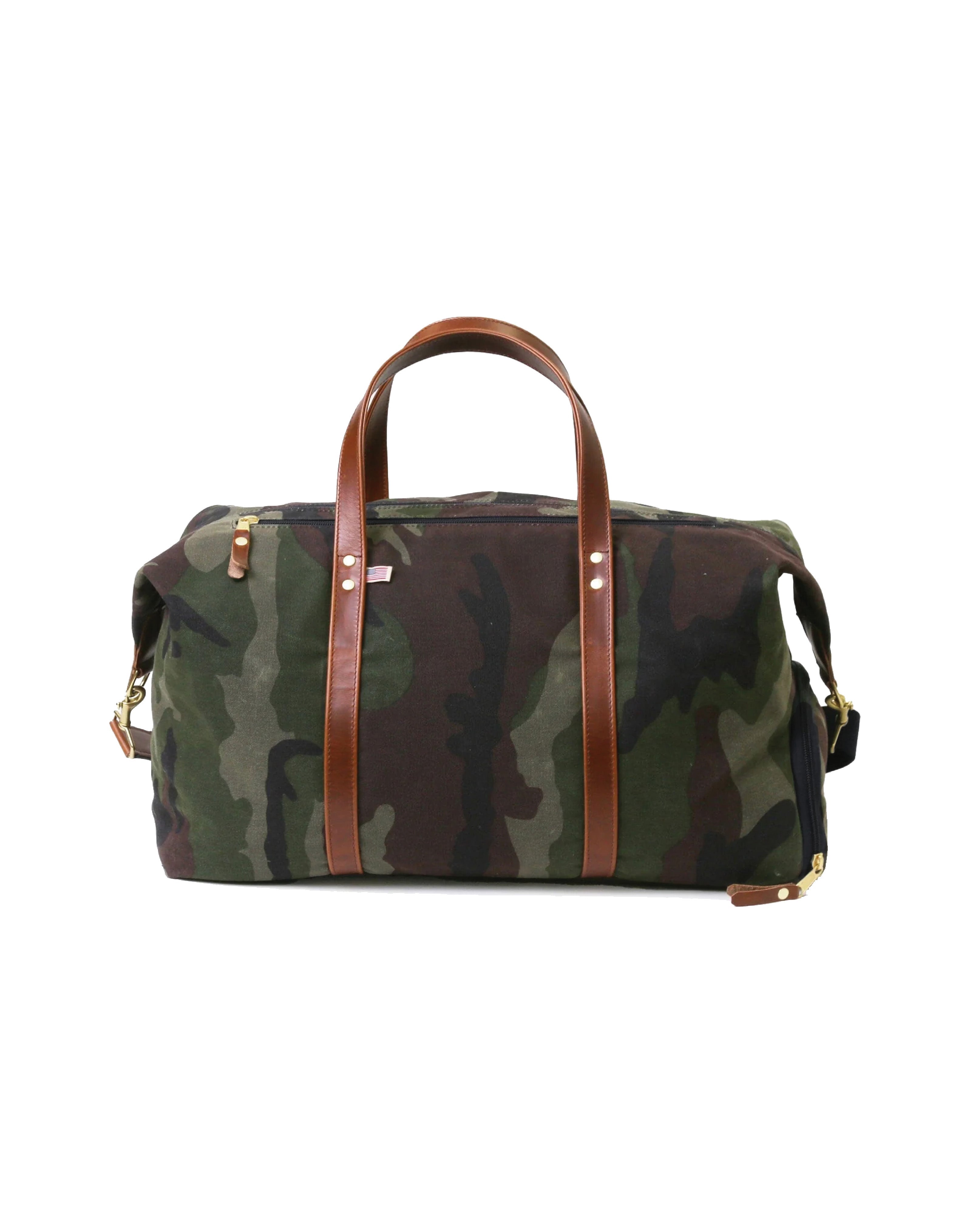 Camouflage duffel bag with brown leather handles and straps on a white background