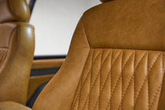 Close-up of tan leather stitched seat detail inside Classic Ford Bronco