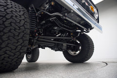 Undercarriage of Classic Ford Bronco showing suspension and large off-road tires