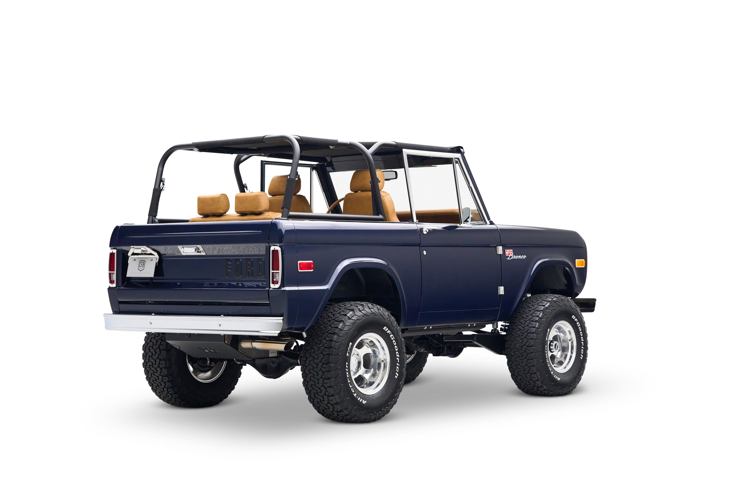 Blue Classic Ford Bronco with open top shown rear 3/4 view on white background