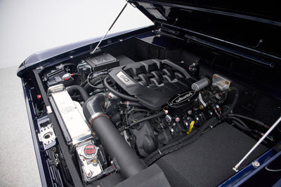 Engine bay of Classic Ford Bronco featuring modern V8 engine with Wilwood components