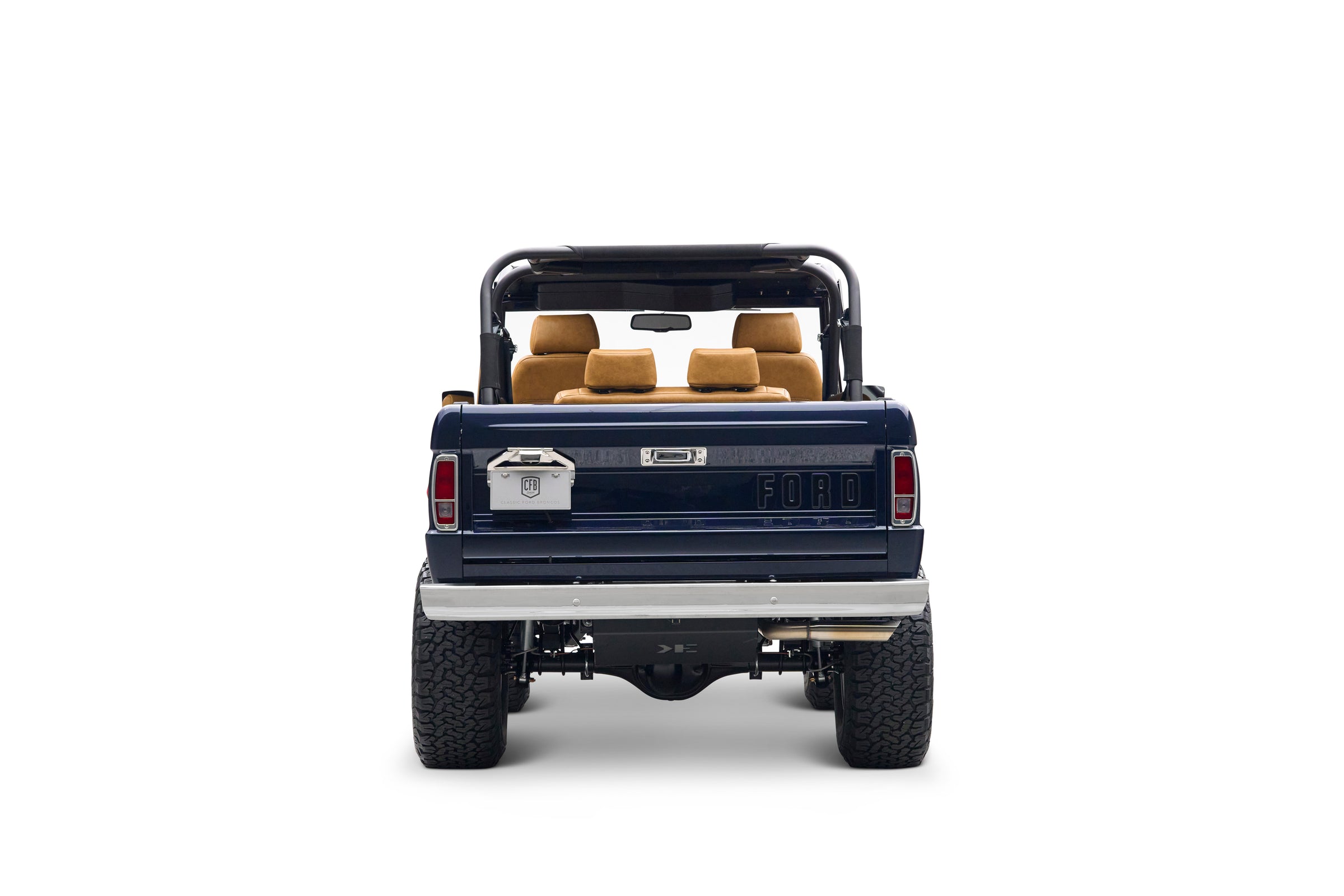 Rear view of navy blue Classic Ford Bronco with tan leather seats and open top