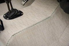 Close-up of fabric upholstery and stitching on floor of classic Ford Bronco.