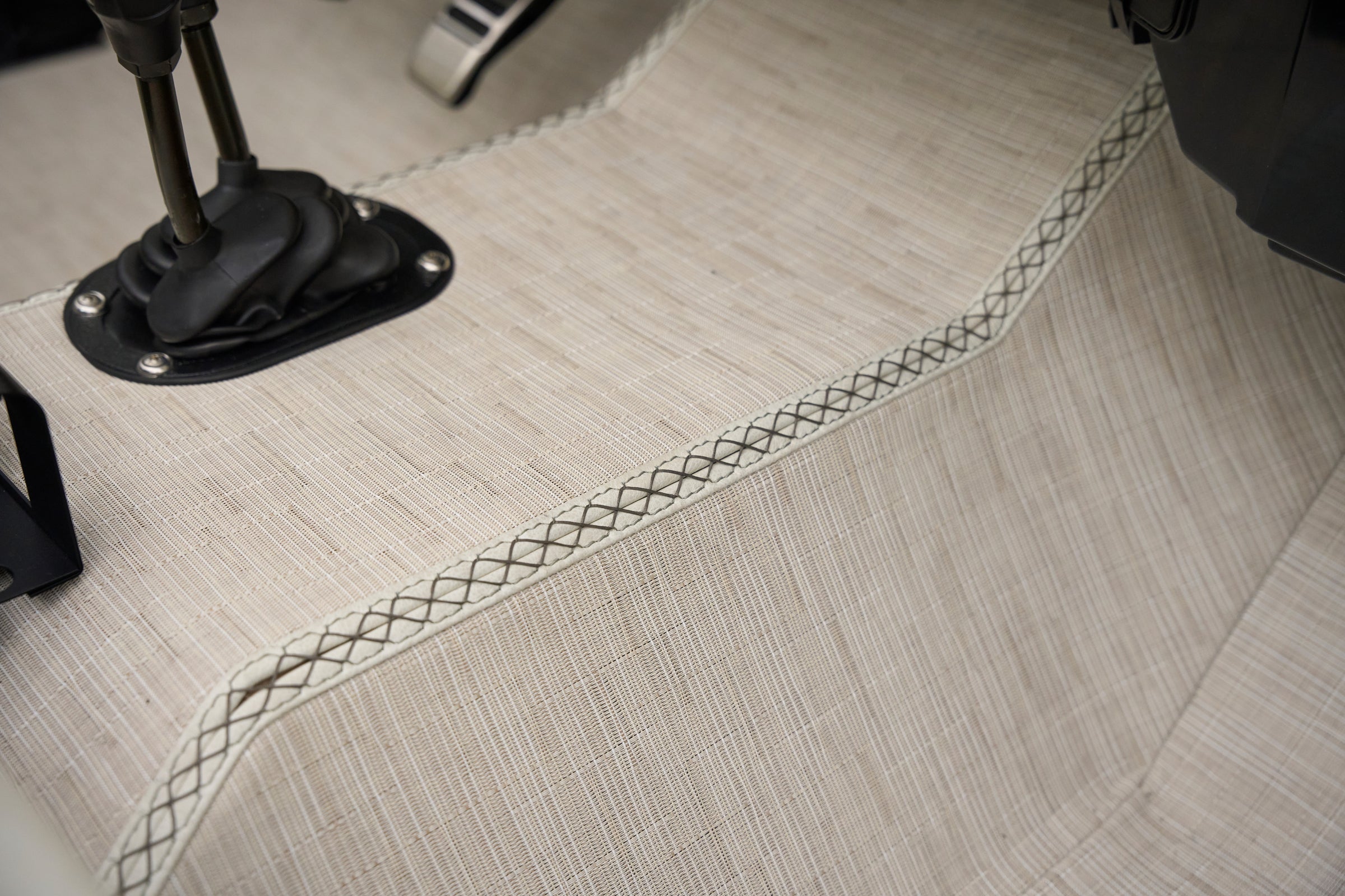 Close-up of fabric upholstery and stitching on floor of classic Ford Bronco.
