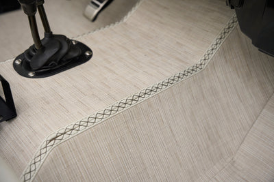 Close-up of fabric upholstery and stitching on floor of classic Ford Bronco.