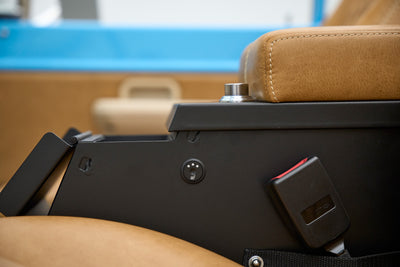 Center console area in Classic Ford Bronco with seat heater control and safety belt buckle