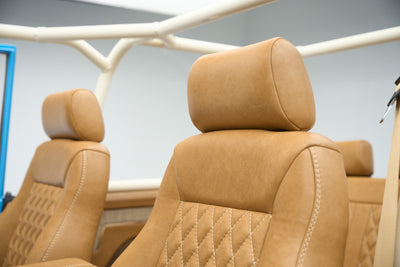 Close detail of tan leather headrests on front seats of Classic Ford Bronco