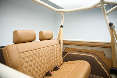 Rear tan quilted bench seat with beige seat belts inside Classic Ford Bronco