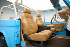 Passenger side tan leather seat and blue door panel inside Classic Ford Bronco