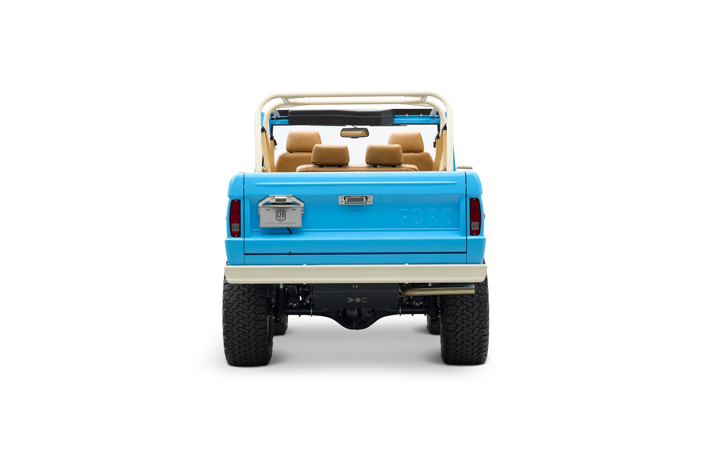 Rear view of light blue Classic Ford Bronco with beige roll cage and seats, license plate visible