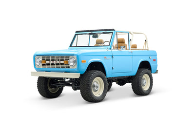 Close-up of front fender showing 'Sport Bronco' emblem on light blue Classic Ford Bronco