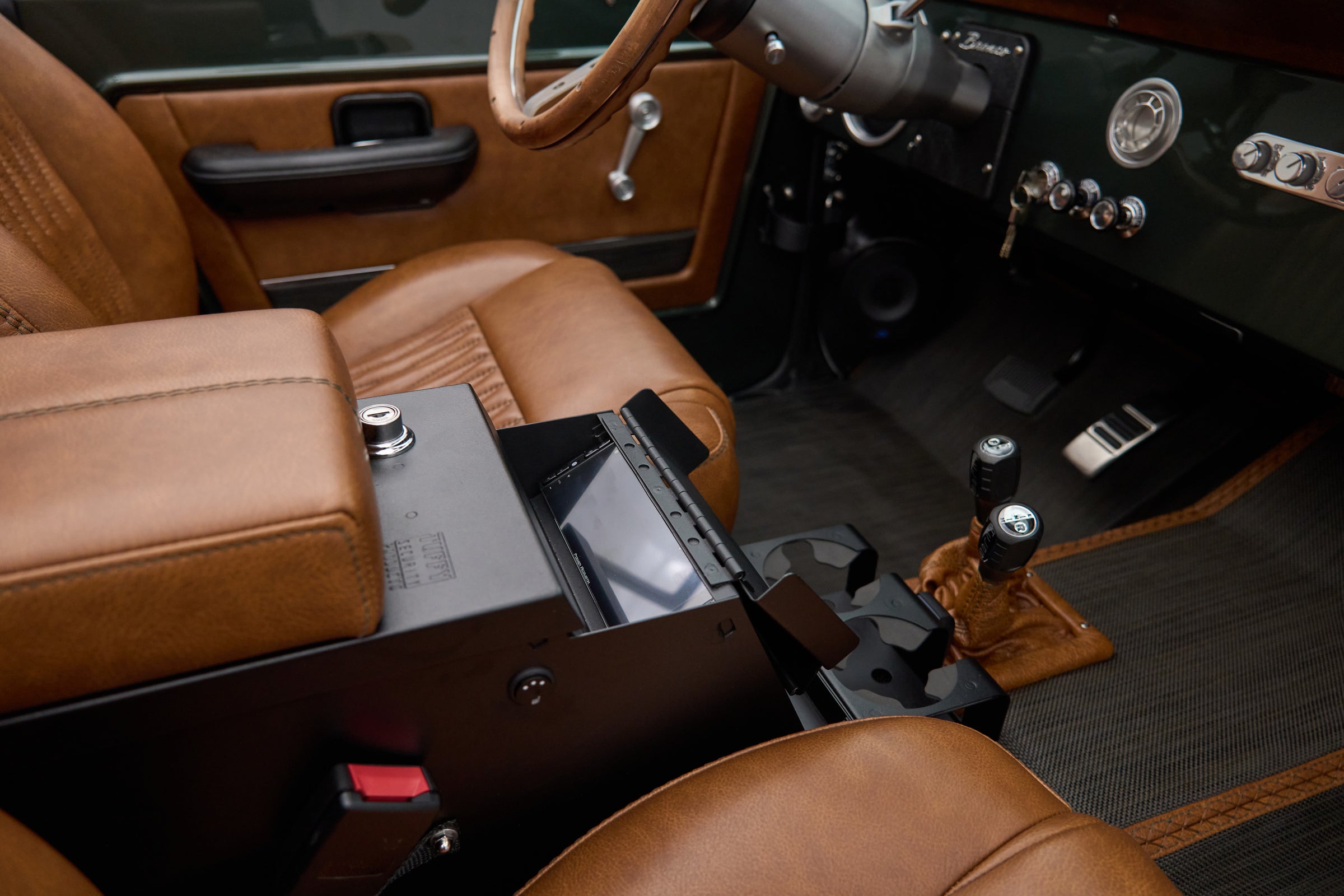 View of tan leather seats and dashboard with open center console in Classic Ford Bronco