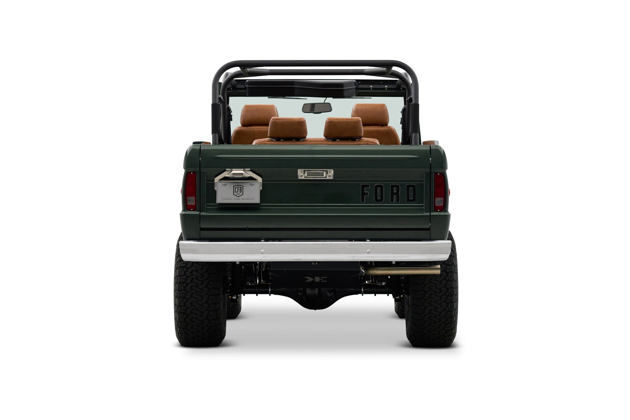 Rear view of Classic Ford Bronco with dark green body and tan seats, open top and roll cage
