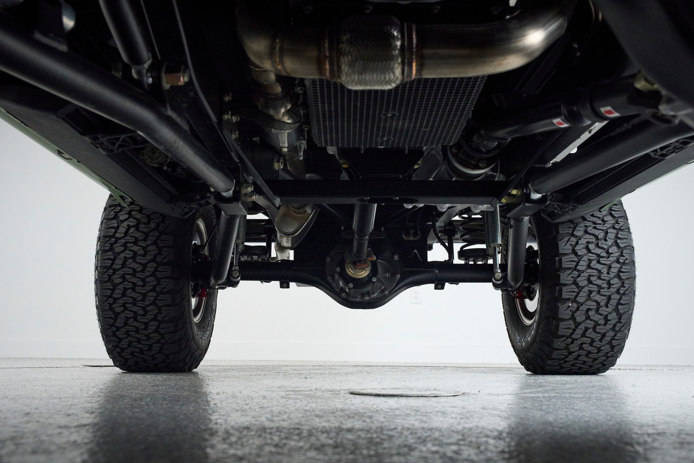 Underbody view of Classic Ford Bronco showing suspension and tires