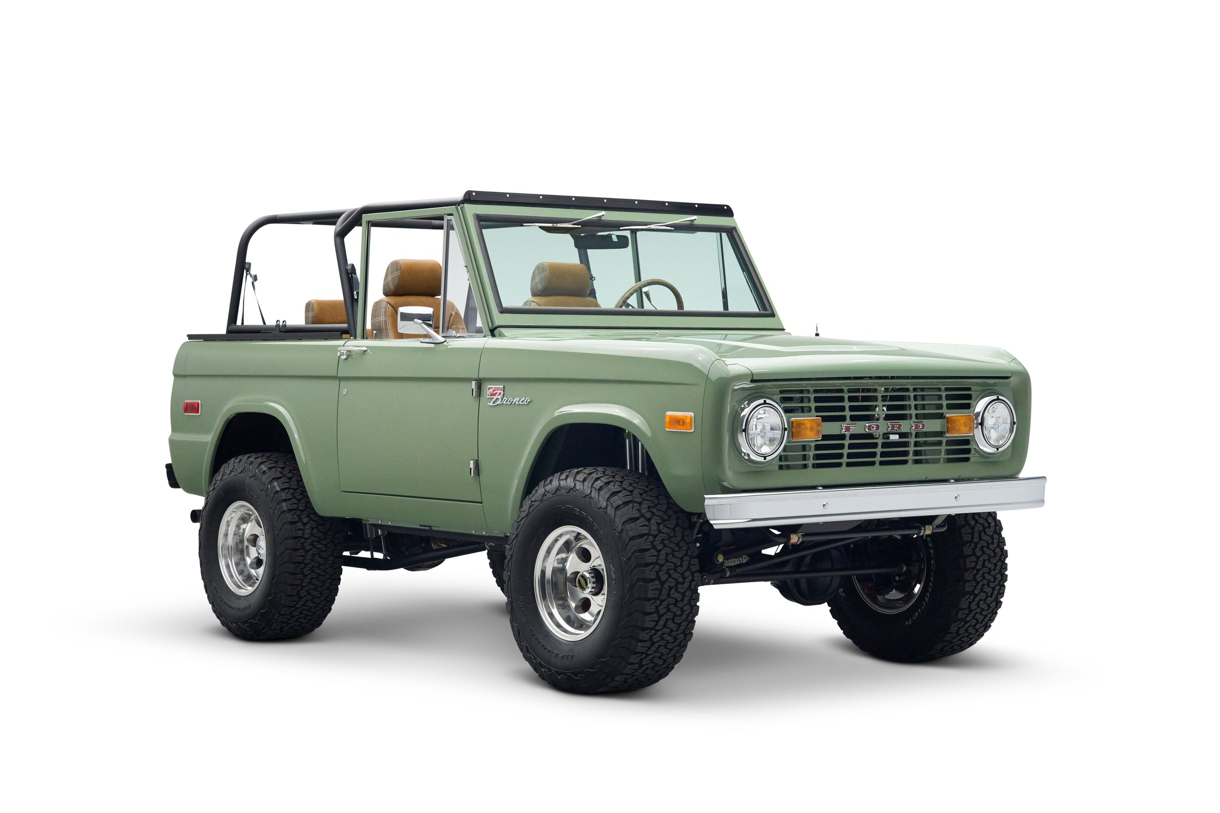 Three quarter front view of green Classic Ford Bronco The Sutton with lifted suspension and open cabin
